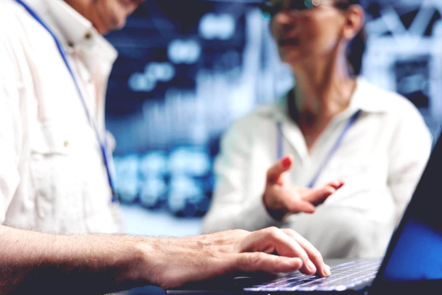 Students collaborating on coding projects in modern workspace