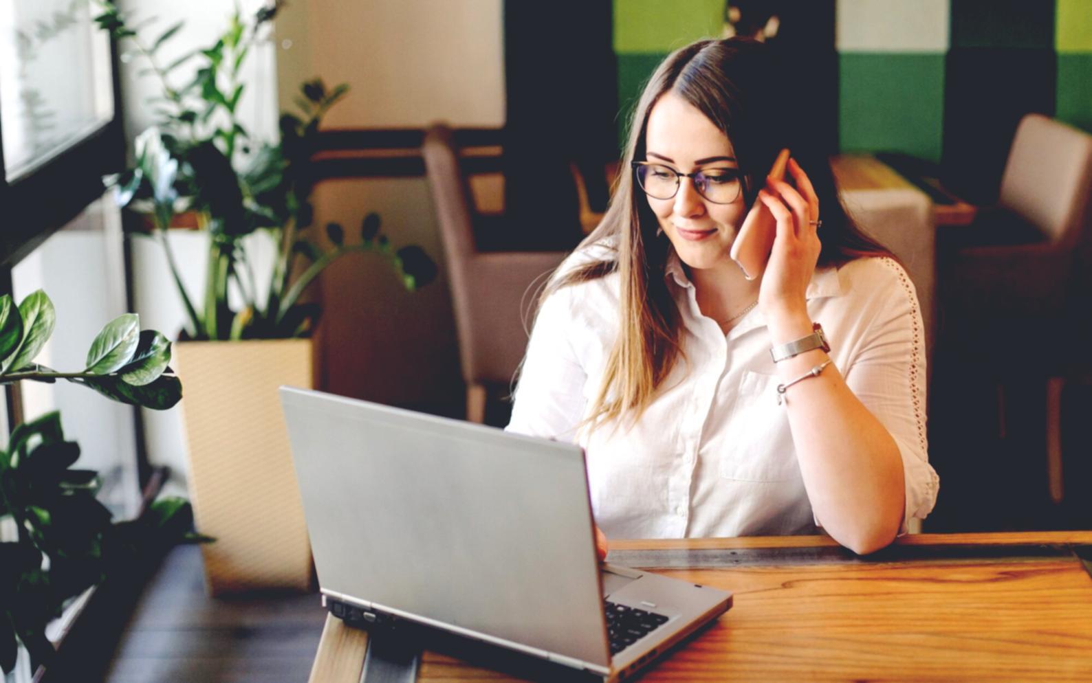 Students collaborating on mobile app development projects in modern learning environment